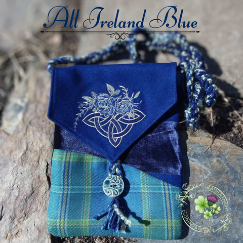 Blue fabric pouch with floral embroidery on a stone surface, featuring 'All Ireland Blue' text.