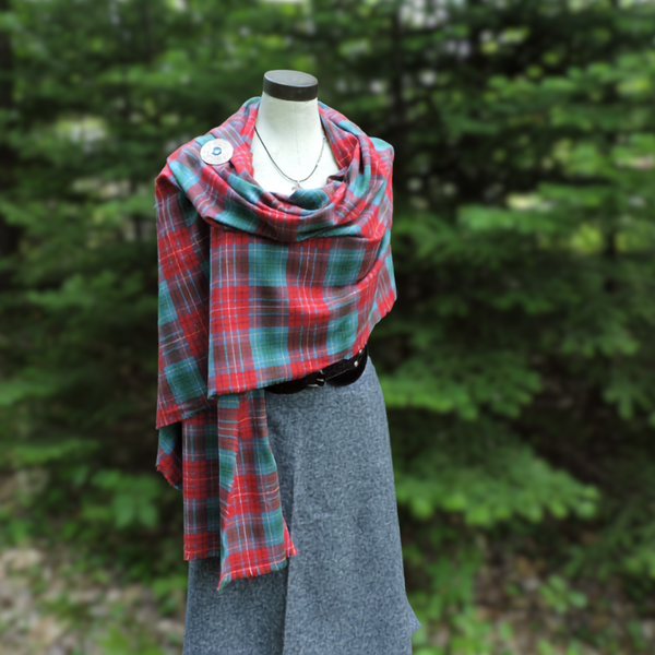 Mannequin wearing a BC tartan scarf with a forest background