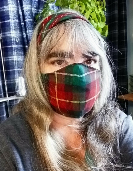 Woman wearing PEI tartan mask and matching headband