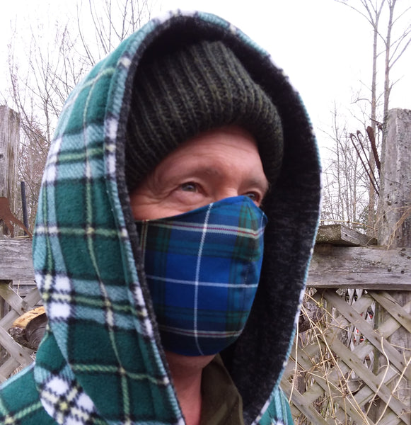 Man wearing Nova Scotia tartan mask with Cape Breton tartan jacket